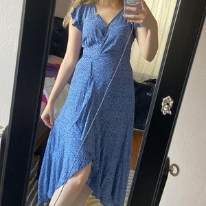 Blue wrap dress with white floral design on it